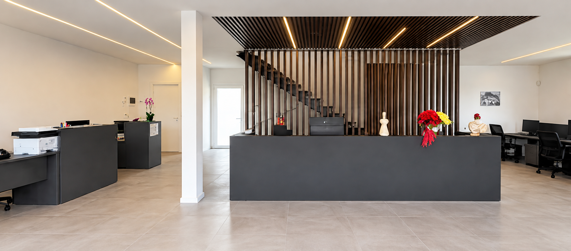 Reception con listelli in legno e illuminazione integrata